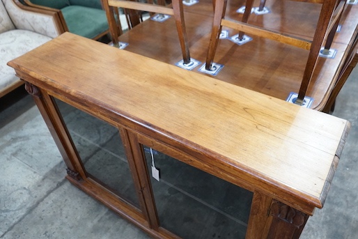 A Victorian and later faded rosewood two door bookcase, width 132cm, depth 33cm, height 90cm